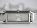 Close-up of the rectangular silver dial with a sunburst finish, 'GUCCI' logo, and 'SWISS MADE' text.