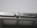 Close-up of the polished crown, subtly embossed with a small 'GUCCI' logo.