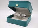 The Gucci 109 watch presented in a teal-coloured Gucci display box with a gold crown emblem.