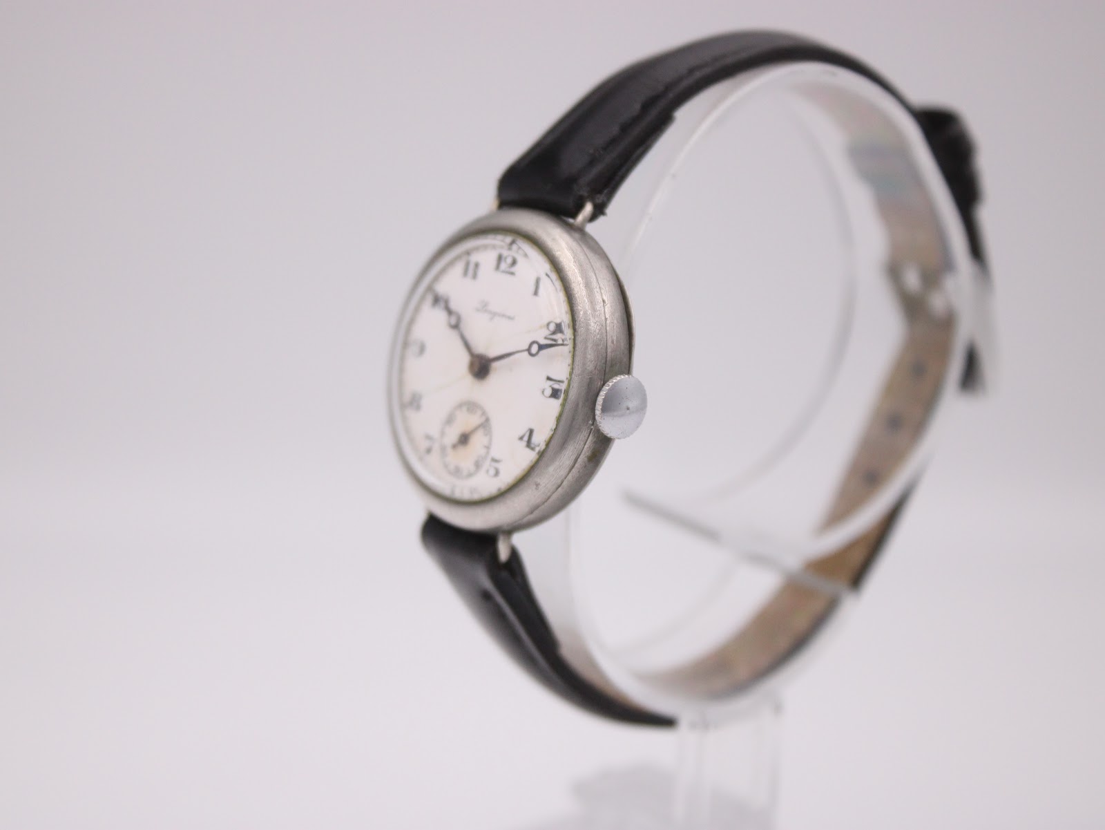 Angled view of the Longines watch, highlighting the silver-tone round case and onion-style crown.