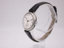 Angled view of the Longines watch, highlighting the silver-tone round case and onion-style crown.
