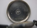 Detailed view of the inside of the case back, showing the Longines winged hourglass logo, serial number 5324374, and internal markings.