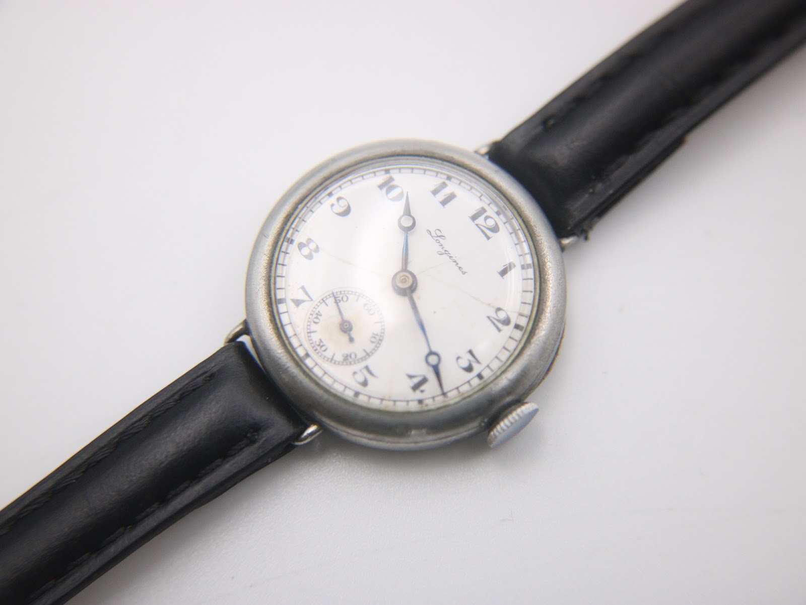 Top-down view of the Longines watch, showcasing the dial and strap on a neutral background.