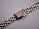 Overhead angled view of the Longines 7751 watch, focusing on the entire length of the stainless steel bracelet and dial.