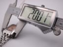 Close-up of a digital caliper measuring the case width of the Longines watch, displaying 20.1mm.