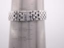 Close-up of the stainless steel bracelet with a signed Longines clasp on a wrist sizing gauge, showing a wrist circumference of 16.5cm.