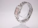 Side profile view of the Longines watch on a clear display stand, highlighting the rectangular case and bracelet.