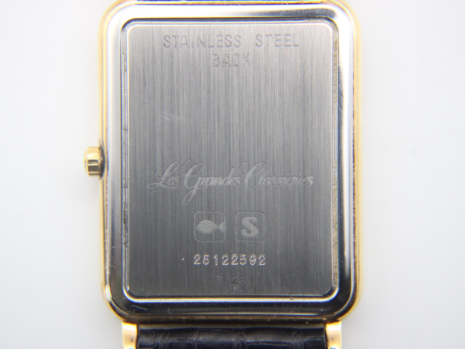 Detailed view of the watch's stainless steel case back, engraved with "Stainless Steel Back", "Les Grandes Classiques", the Longines emblem, serial number 26122592, and model 7426.