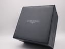 The closed original dark blue Longines watch box with the Longines logo on the lid.