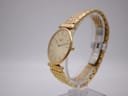 Angled side view of the Longines watch, highlighting the slim profile of the gold case and the multi-link bracelet.