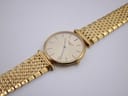Overhead view of the Longines watch with the gold multi-link bracelet laid flat, showcasing the overall design.