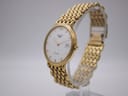 Angled view of the Longines Flagship watch on a display stand, highlighting the slim profile of the gold-tone case and the detailing of the bracelet.