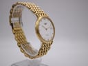 Side profile view of the Longines Flagship watch on a display stand, showing the crown and the curvature of the gold-tone case.