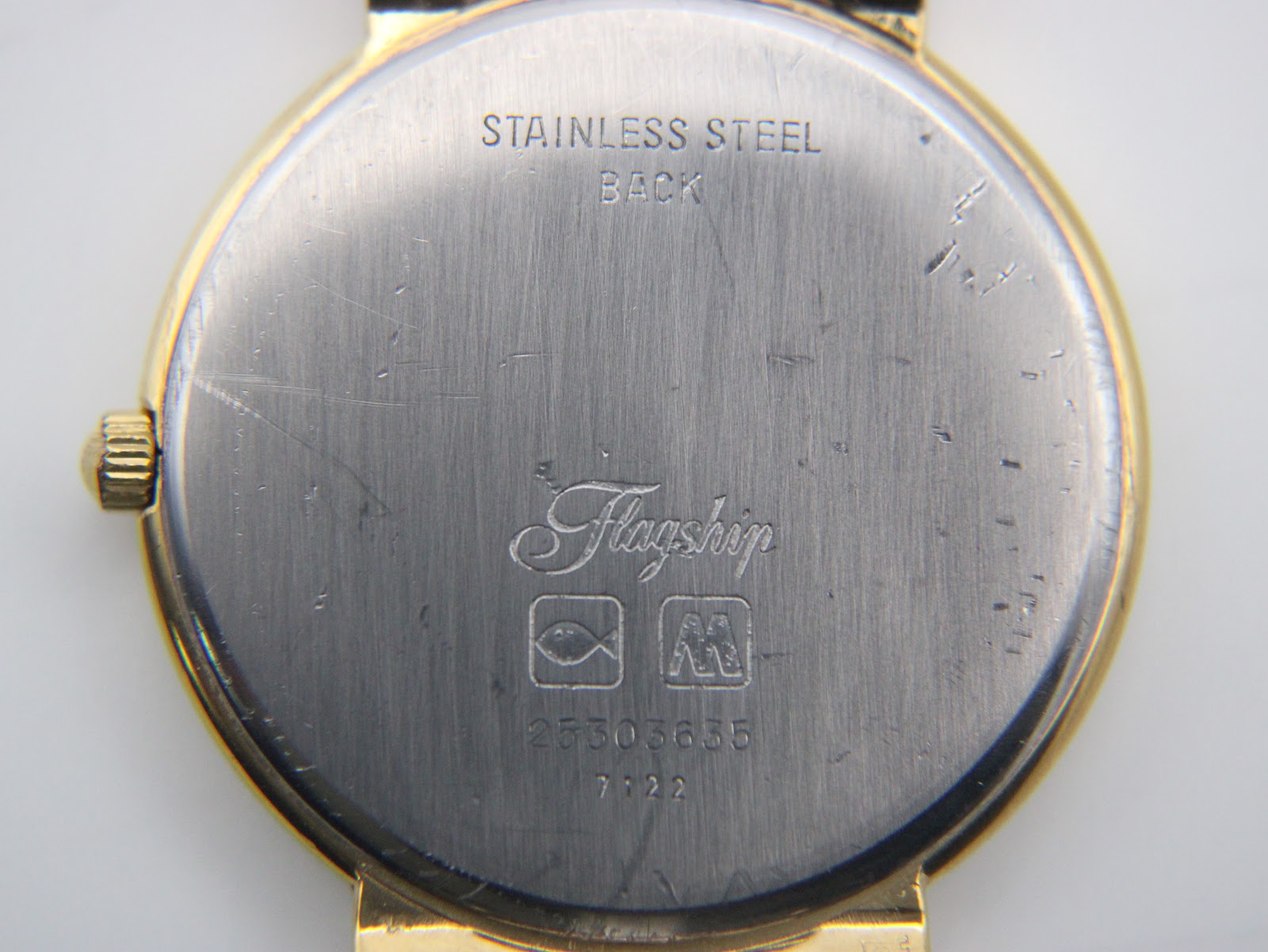 Close-up of the stainless steel case back of the Longines Flagship, revealing "Stainless Steel Back", "Flagship" engraving, and serial number 25303635.