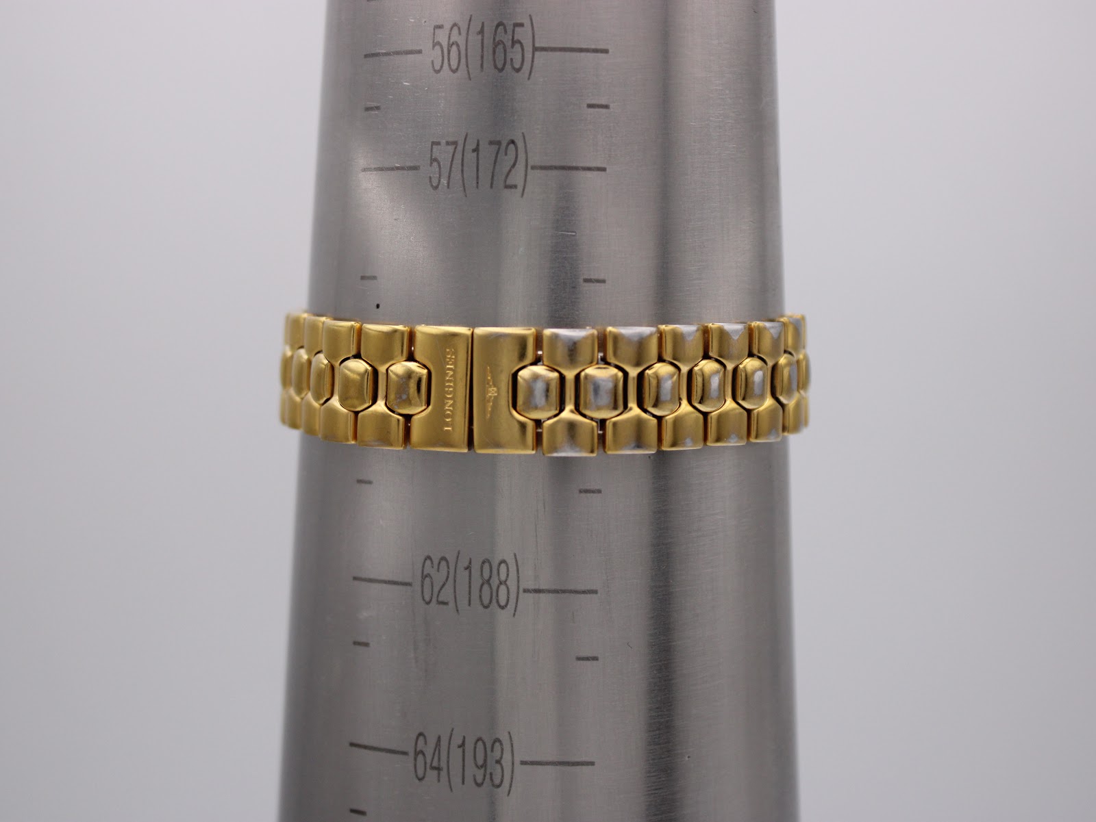 Longines Conquest watch bracelet on a wrist sizing gauge, showing a wrist circumference of 165mm.