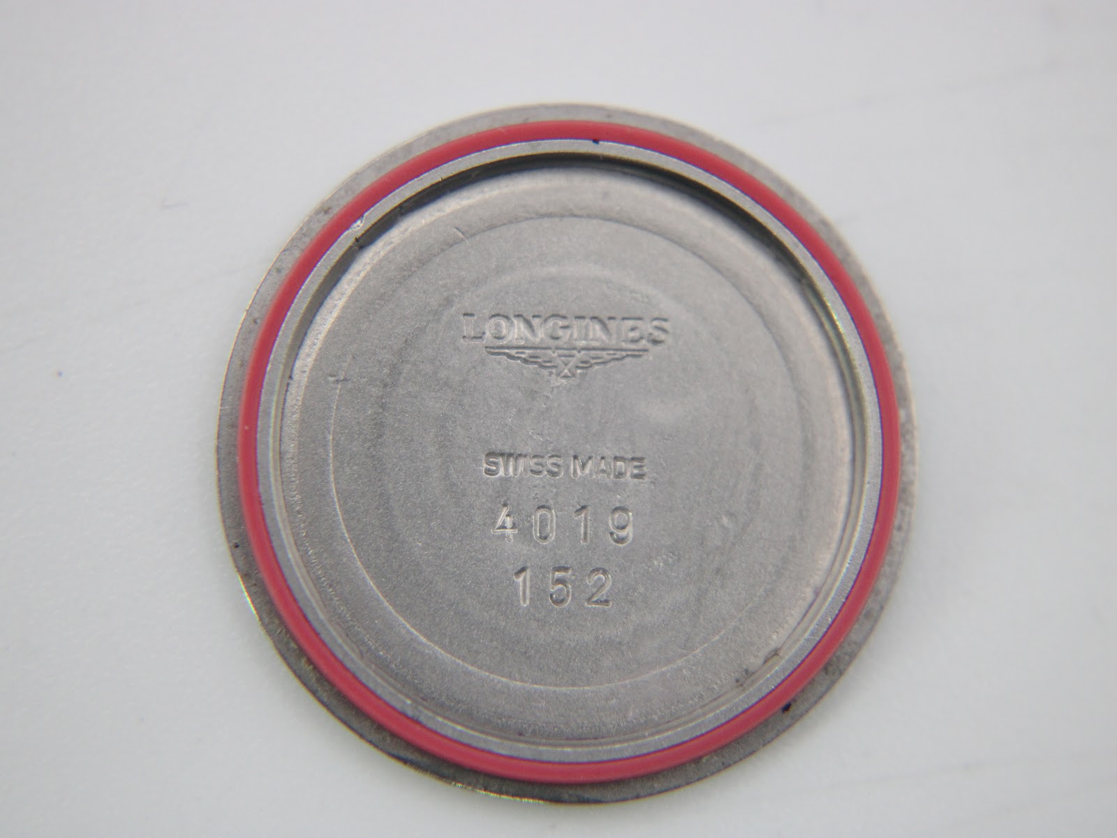 Inside of the case back with "Longines" and "Swiss Made" engravings, plus a red gasket.