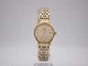 Angled side view of the Longines Lyre watch showing the gold-tone case, crown, and a small mark on the side.