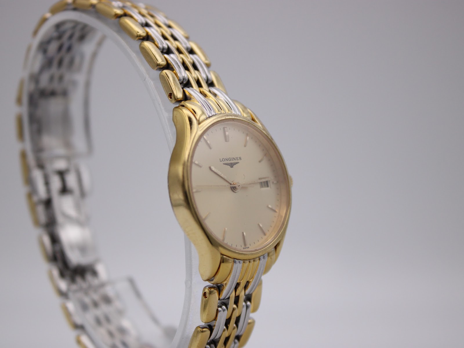 Opposite angled side view of the Longines Lyre watch, highlighting the smooth lines of the gold-tone case.
