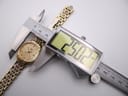 Long shot of the Longines Lyre watch and its full two-tone stainless steel bracelet on a white surface.
