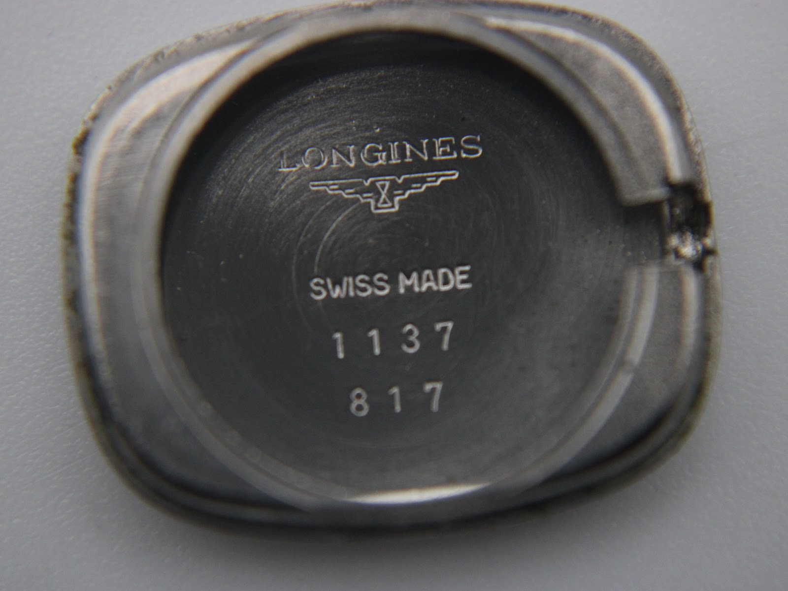 Close-up of the watch case back, showing Longines logo, "Swiss Made", and reference numbers 1137 817.