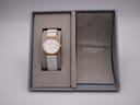 Overhead view of the Longines Presence watch resting in its open original grey box.