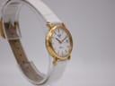 Angled side view of the Longines Presence watch on a display stand, showcasing the opposite side of the gold-tone case.