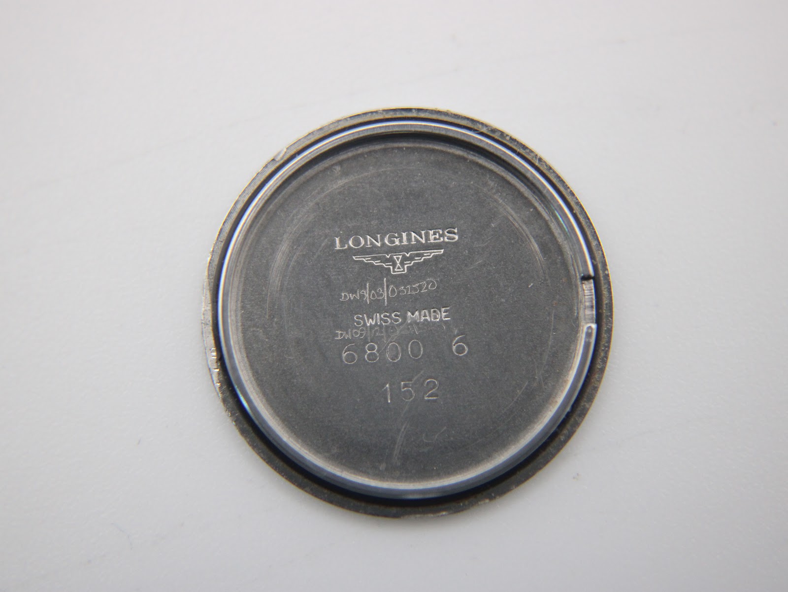 Close-up of the inner case back, revealing "LONGINES", "SWISS MADE", and "6800 6" engravings.