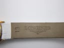 Underside of the white leather strap, clearly showing the embossed "LONGINES" logo and "13" indicating the lug width.