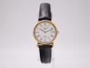 Clear front view of the Longines watch, showcasing its white dial with Roman numerals, gold-tone case, and black leather strap.