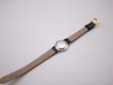 Rear view of the Longines watch, displaying the polished stainless steel case back and the full length of the black leather strap with its gold-tone buckle.