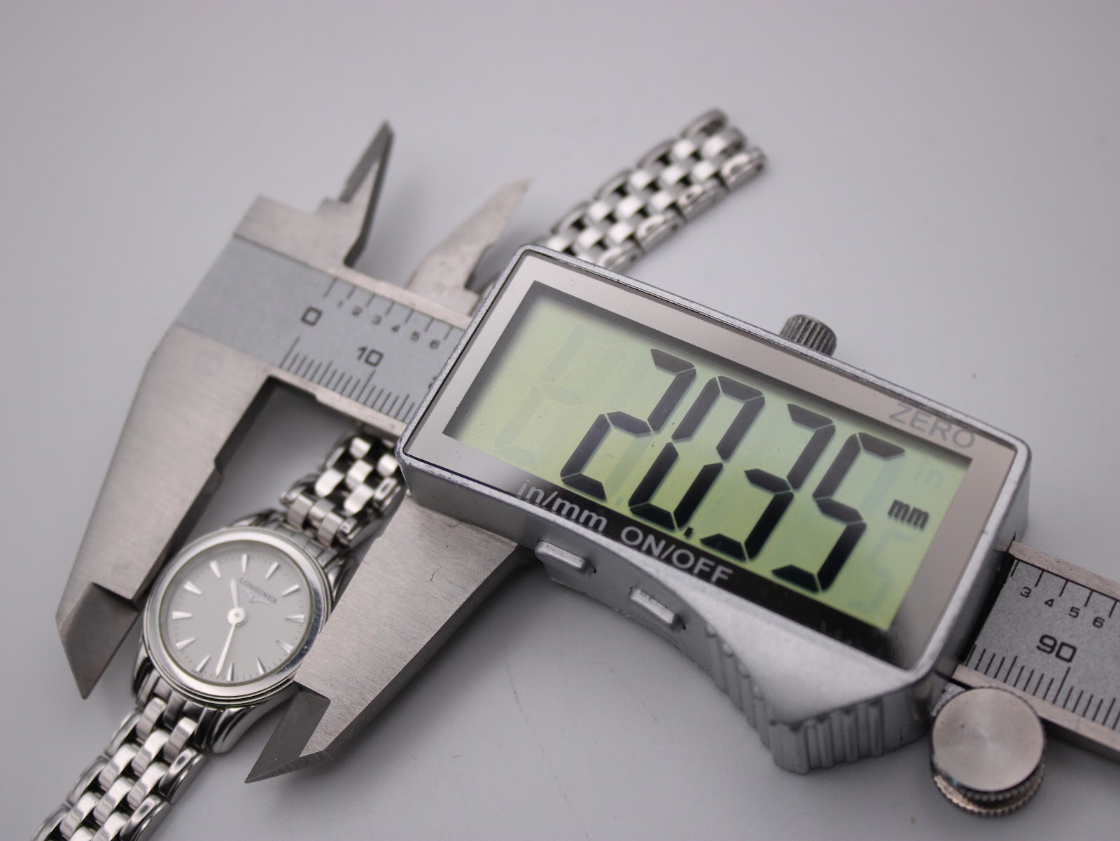 Digital caliper displaying the case diameter of the Longines L4.215.4 watch as 20.35mm.