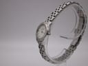Side profile view of the Longines L4.215.4 watch on a clear stand, highlighting the curved case and bracelet design.