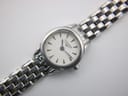 Detailed close-up of the white dial with Longines logo, baton hour markers, and black hands.
