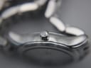Close-up of the watch crown, featuring the embossed Longines winged hourglass logo.