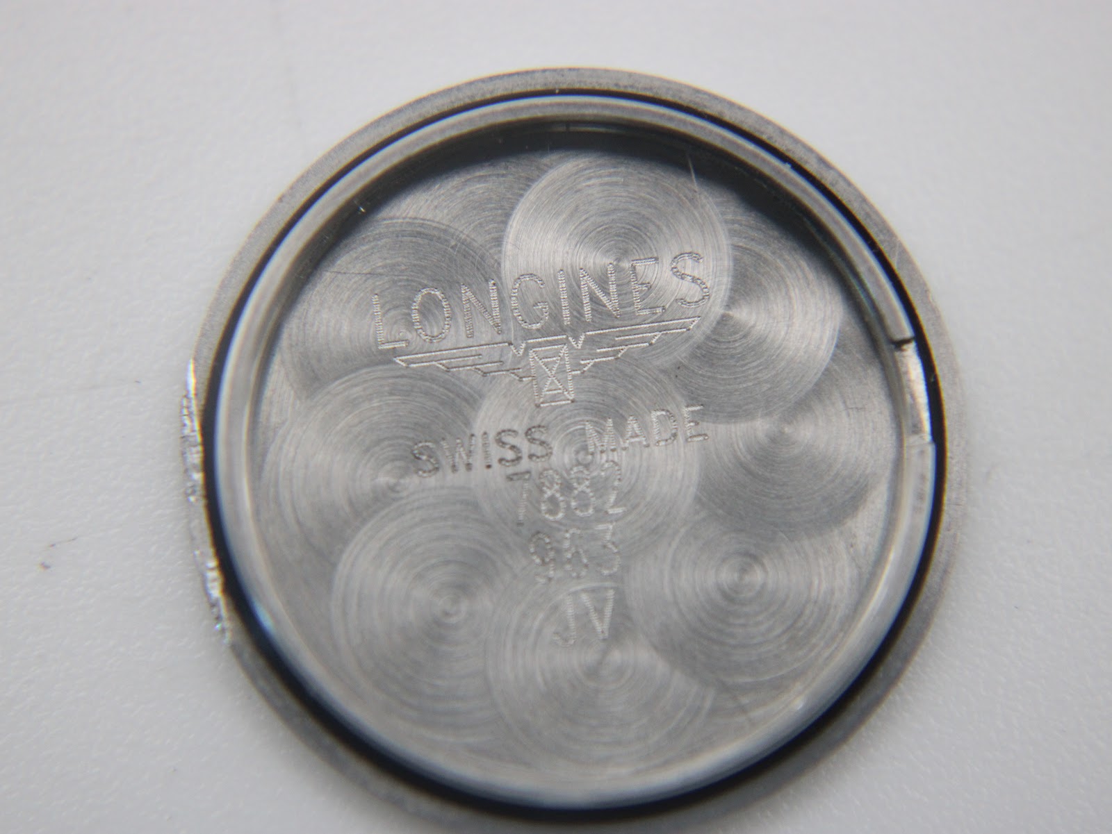 Inside of the case back with "LONGINES SWISS MADE" and "STAINLESS STEEL" engravings.