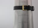 Close-up of the green leather strap fastened on a wrist sizing gauge, showing it fits a wrist of approximately 16.5cm.