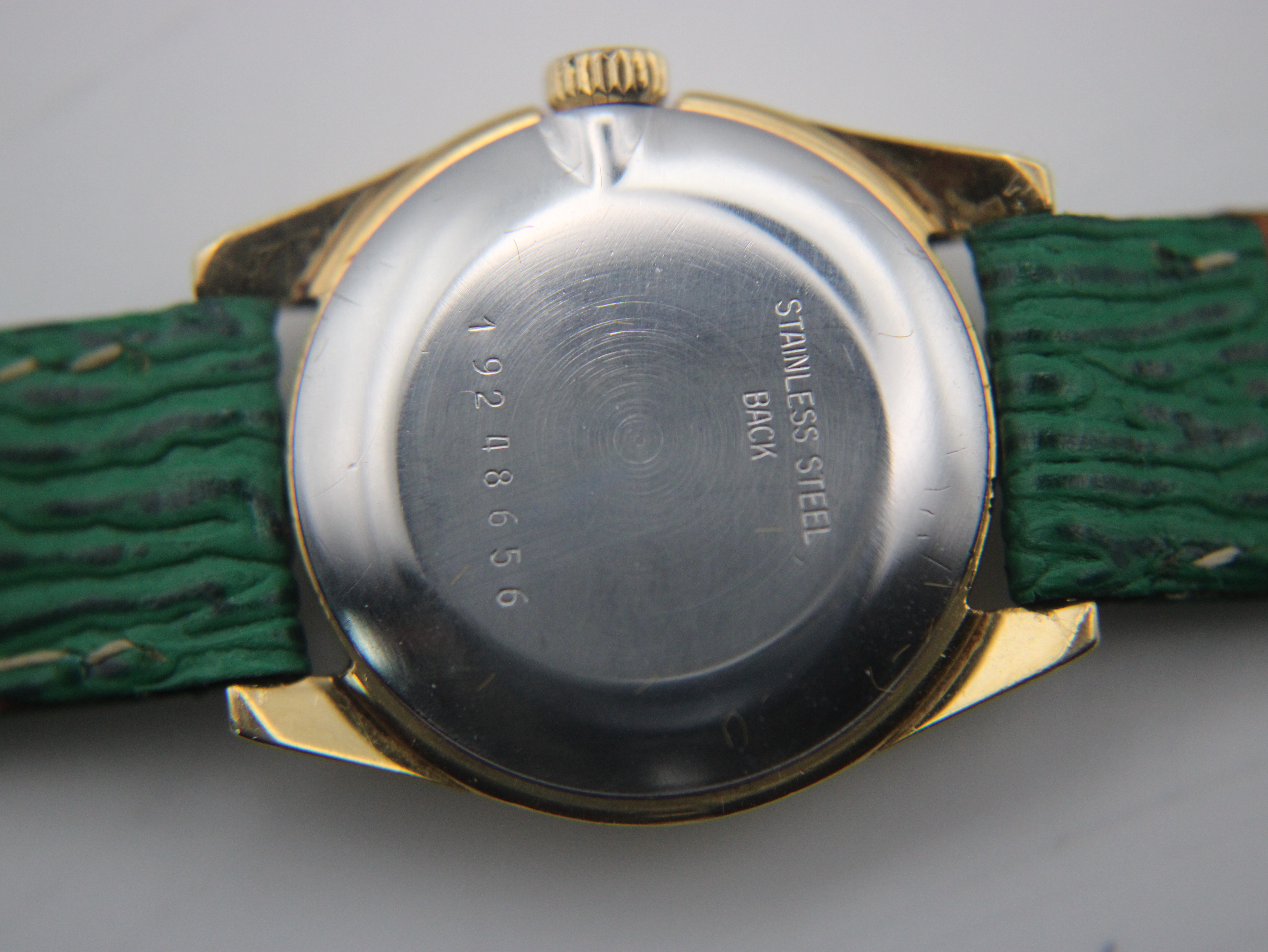 Macro shot of the Longines watch stainless steel case back, revealing the serial number '19248656' and 'Stainless Steel Back'.