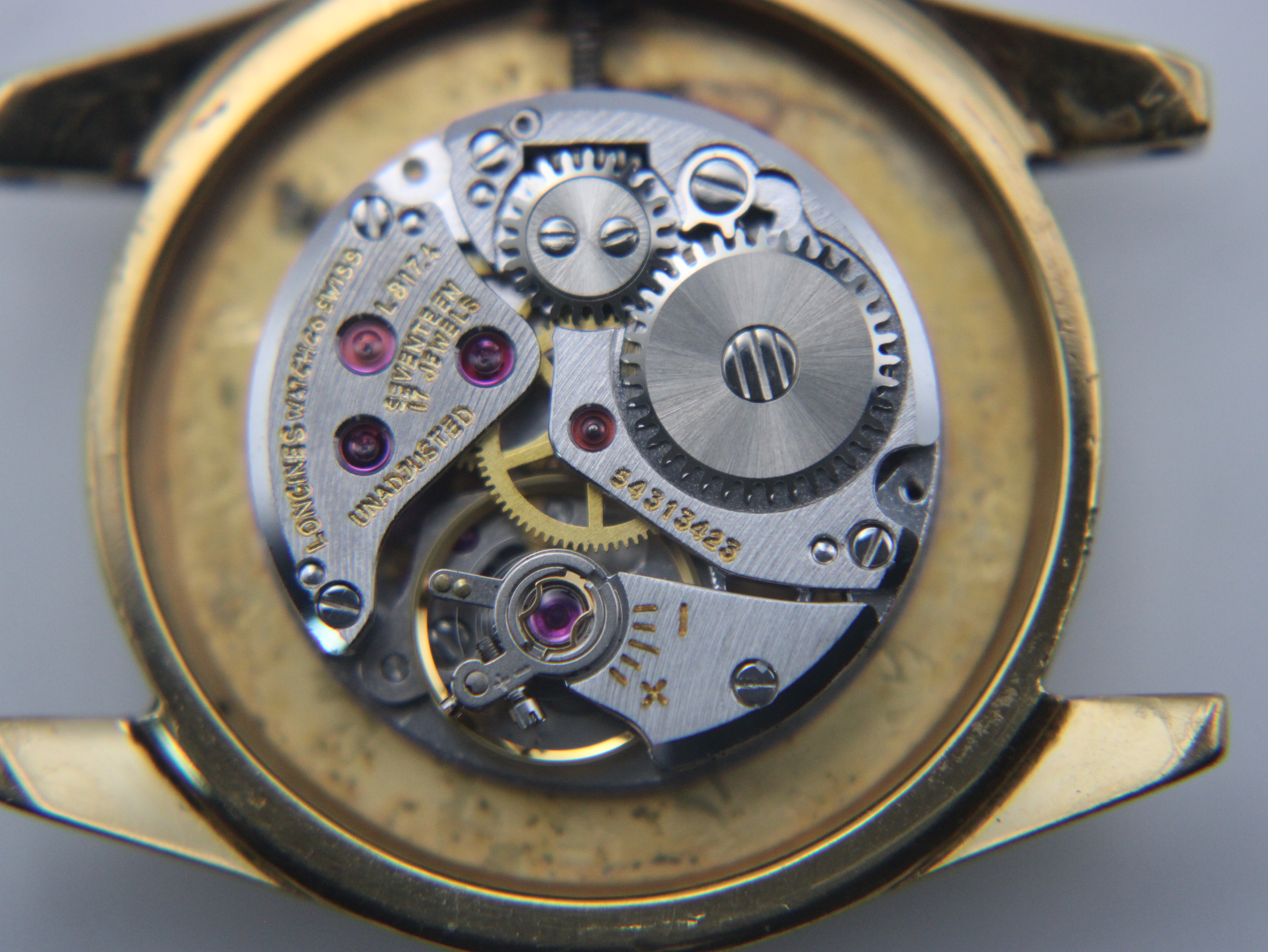 Close-up view of the intricate Longines manual wind movement (calibre L.817.4) inside the watch case.