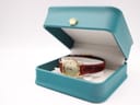 The Longines watch presented inside its original teal-coloured Longines box with a gold crown emblem.