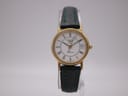 Front view of the Longines Presence watch with white Roman numeral dial, gold case, and green leather strap on a stand.