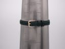 Green leather strap on a wrist sizing gauge, showing a circumference measurement of 165mm / 16.5cm.