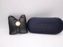 The Longines Presence watch resting on a black watch cushion next to its original dark blue Longines presentation box.