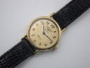 Close-up, top-down view of the watch dial, clearly showing "Longines Quartz Presence" text and Arabic numerals.