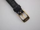 Close-up of the gold-tone pin buckle with the engraved Longines winged hourglass logo.