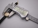 Digital caliper measuring the watch case, displaying a precise diameter of 20.06mm.