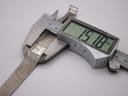 Digital caliper measuring the watch case diameter at precisely 15.18mm.