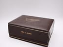 Closed original Longines watch box, brown with 'Mrs. C. Byrne' written on the front.