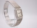 Another angled view of the silver Longines watch, highlighting its square dial and integrated bracelet design.