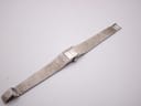 Top-down view of the full Longines watch with its textured sterling silver integrated bracelet laid flat.