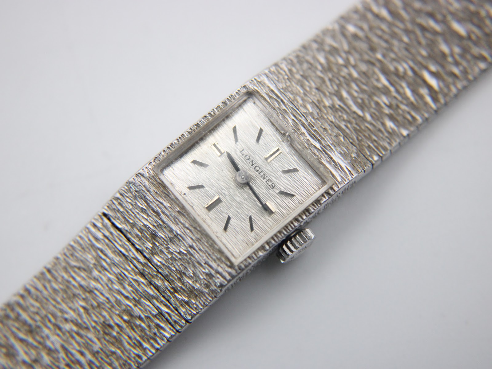 Close-up front view of the Longines 410's silver dial with applied baton indices and subtle texture.